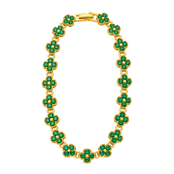 Gold tone tennis bracelet with four leaf clover shaped links. 