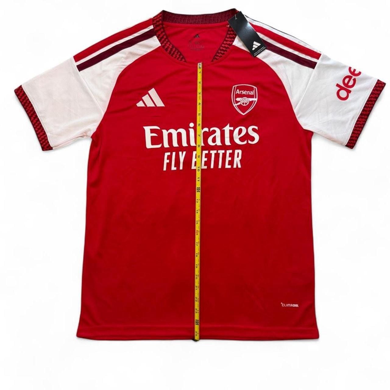 Adidas Arsenal 2026/27 home shirt in red with white sleeves and red stripes number seven Saka on the back size XL dimensions in the pictures brand new with tags. 3