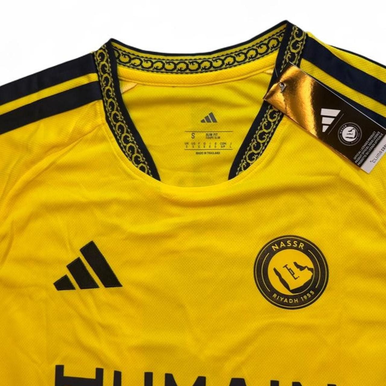 Adidas Al Nassr 2026/27 home jersey in yellow with black stripes on shoulders and black trim on collar and sleeves number 7 Ronaldo on the back size small dimensions are in the pictures brand new with tags. 7