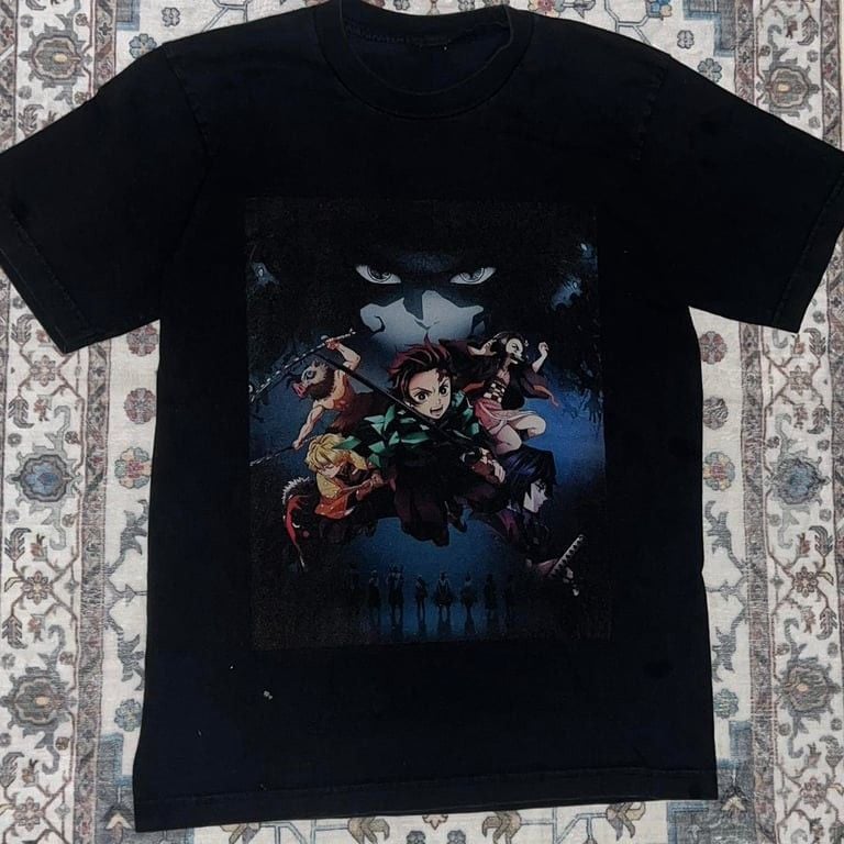 Demon Slayer Size Anime Graphic Tee. Really Cool Graphic of Anime and their Characters. Thick and Quality Cotton Shirt in Great Preloved Condition. Minor fading and a few stains mainly on the back. Great for any Demon Slayer or Anime fan!!!
Size - L (no 2