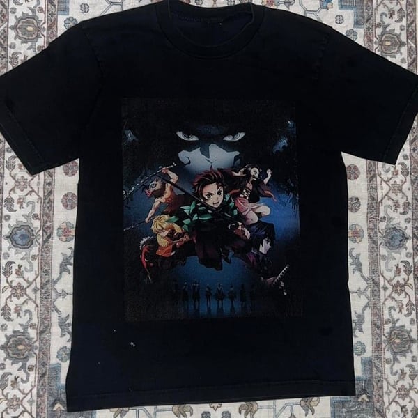 Demon Slayer Size Anime Graphic Tee. Really Cool Graphic of Anime and their Characters. Thick and Quality Cotton Shirt in Great Preloved Condition. Minor fading and a few stains mainly on the back. Great for any Demon Slayer or Anime fan!!!

Size - L (no