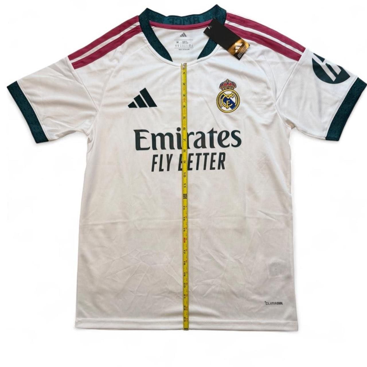 Adidas Real Madrid 2026/27 home shirt in white with maroon and dark green stripes on shoulders and sleeves, number 5 Bellingham on the back size Medium dimensions in the pictures brand new with tags. 3