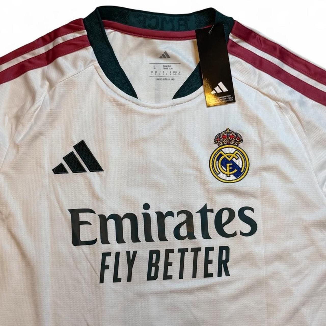 Adidas Real Madrid 2026/27 Home Jersey White with maroon and green stripes on shoulders and sleeves number 5 Bellingham on the back size Large dimensions in the pictures brand new with tags. 5