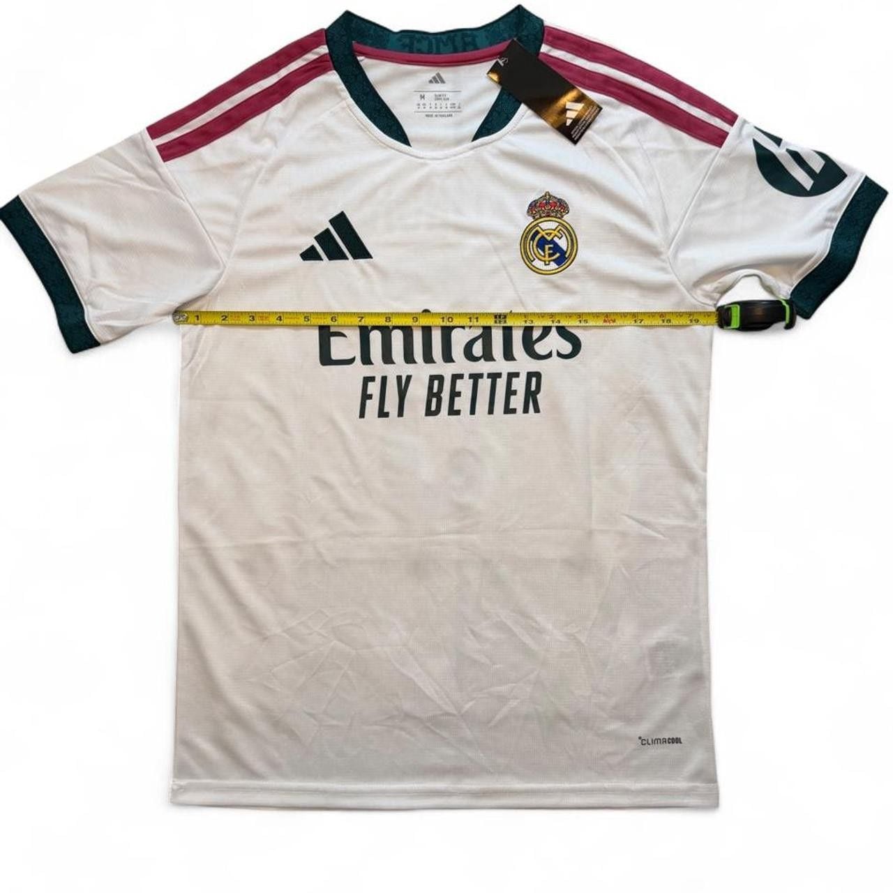 Adidas Real Madrid 2026/27 home shirt in white with maroon and dark green stripes on shoulders and sleeves, number 5 Bellingham on the back size Medium dimensions in the pictures brand new with tags. 4