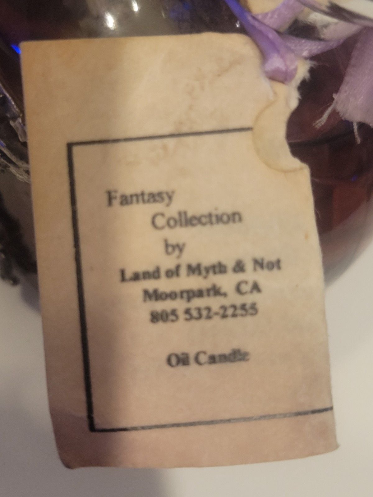 Land of Myth & Not" purple oil candle featuring a pewter fairy on a moon design. 10