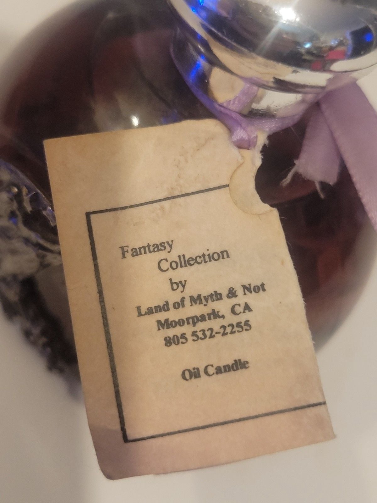 Land of Myth & Not" purple oil candle featuring a pewter fairy on a moon design. 11