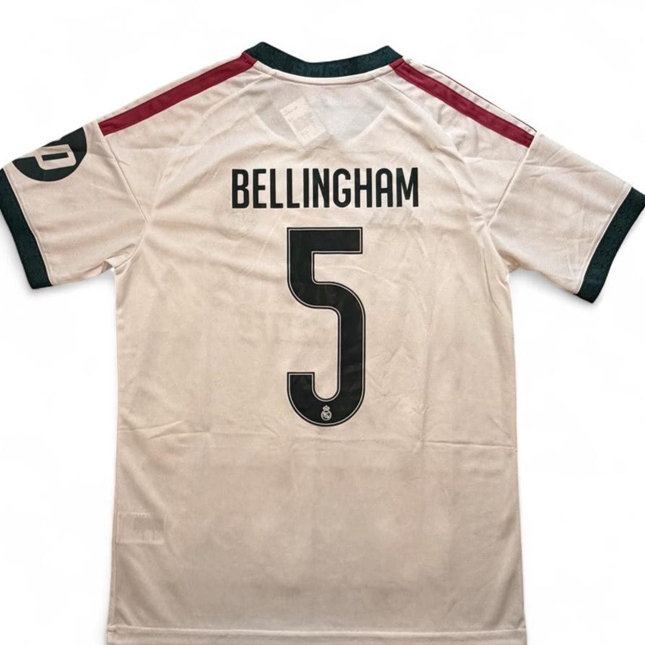 Adidas Real Madrid 2026/27 home shirt in white with maroon and dark green stripes on shoulders and sleeves, number 5 Bellingham on the back size Medium dimensions in the pictures brand new with tags. 8