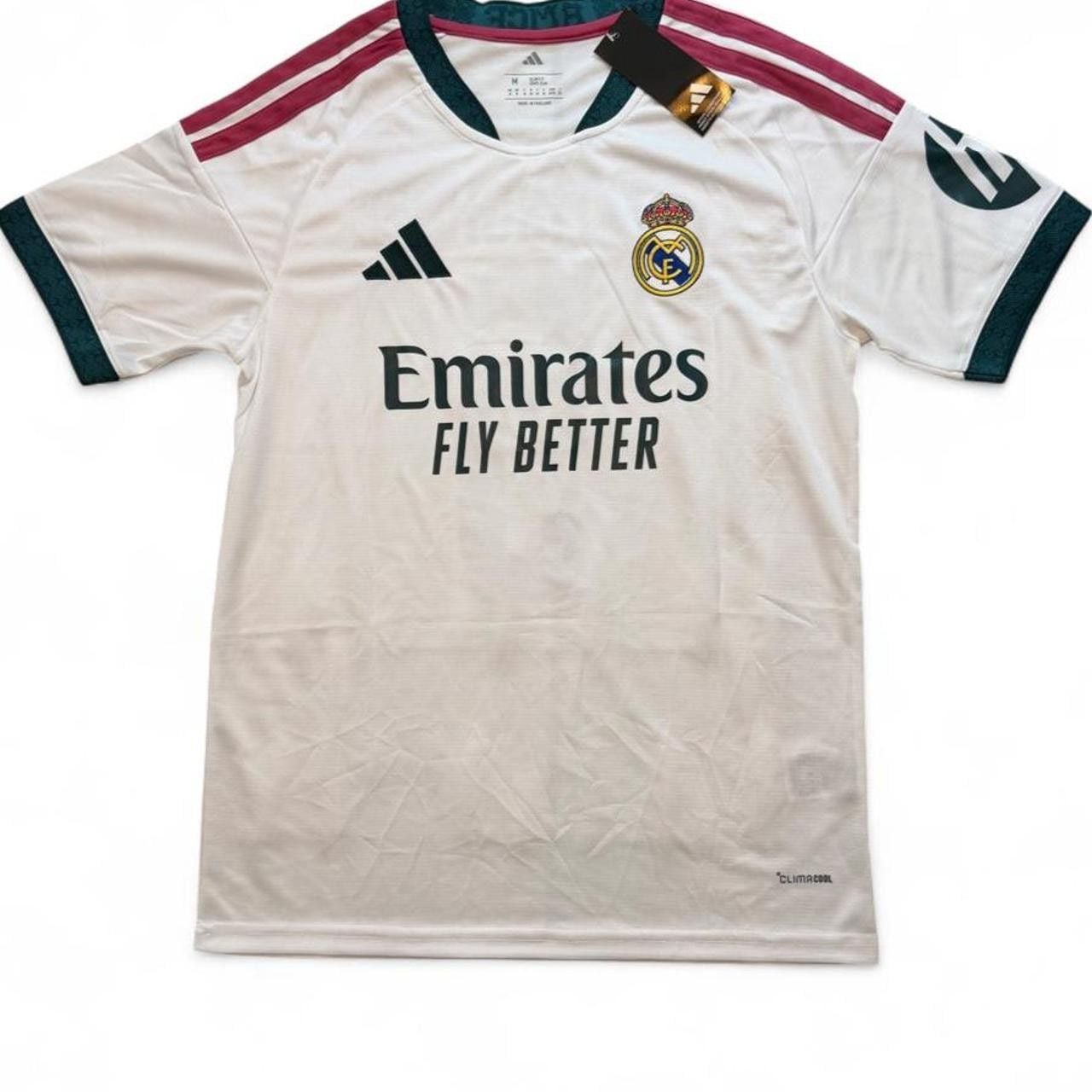 Adidas Real Madrid 2026/27 home shirt in white with maroon and dark green stripes on shoulders and sleeves, number 5 Bellingham on the back size Medium dimensions in the pictures brand new with tags. 2