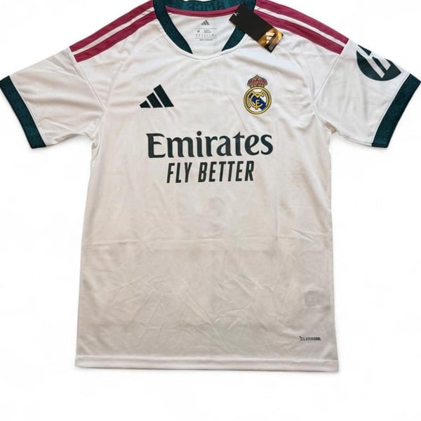 Adidas Real Madrid 2026/27 home shirt in white with maroon and dark green stripes on shoulders and sleeves, number 5 Bellingham on the back size Medium dimensions in the pictures brand new with tags.