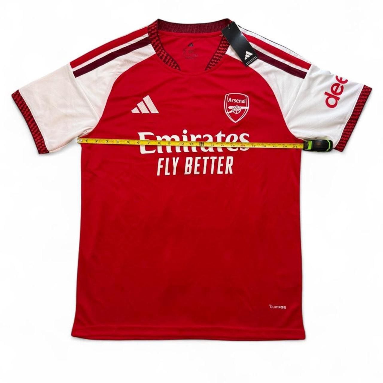 Adidas Arsenal 2026/27 home shirt in red with white sleeves and red stripes number seven Saka on the back size XL dimensions in the pictures brand new with tags. 4