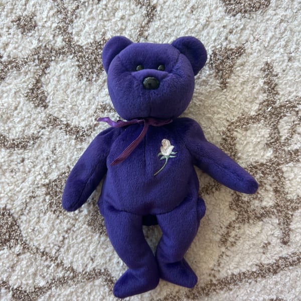 TY “Princess” Diana Memorial Beanie Baby — the purple bear with the white rose.