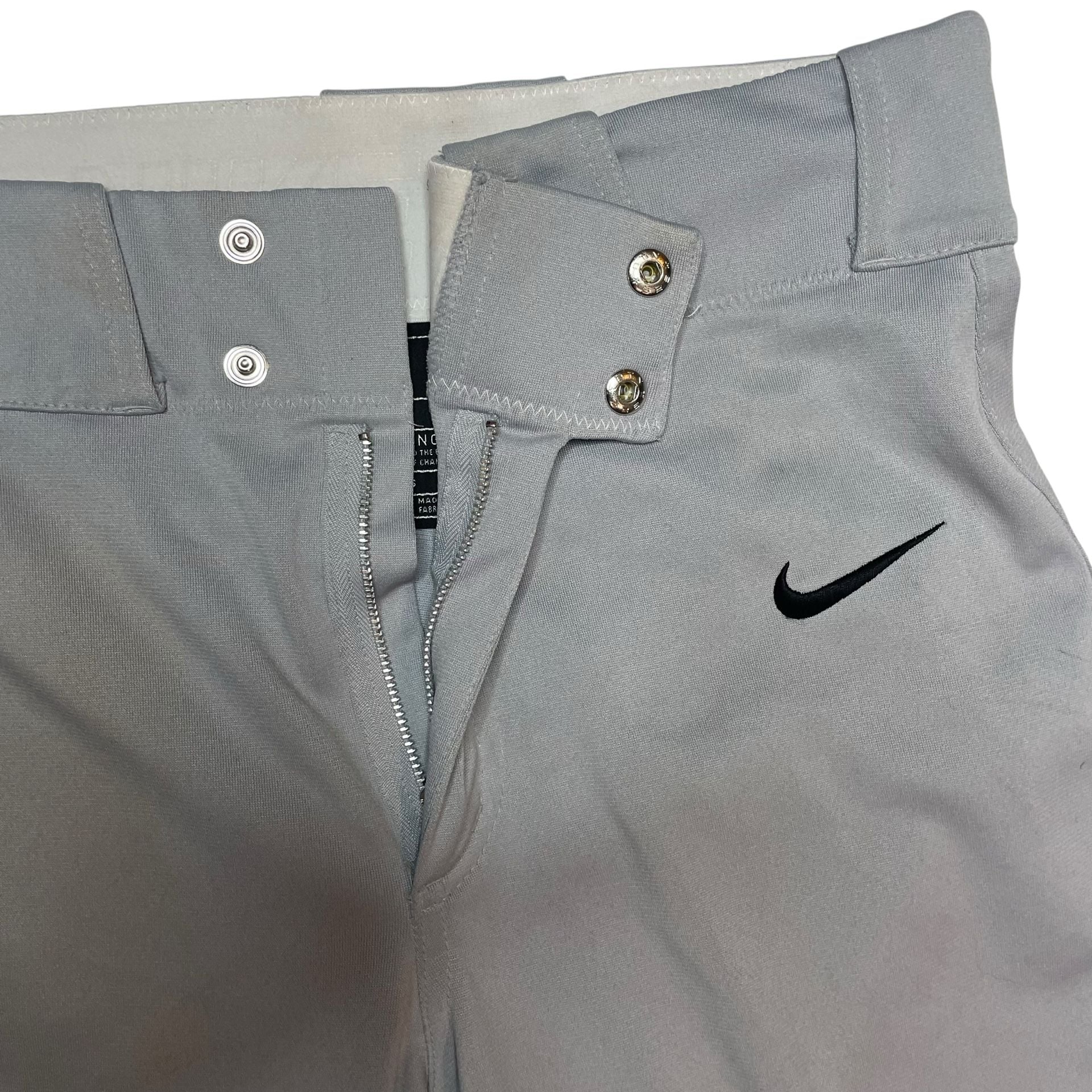Nike Team Gray Baseball Pants Youth Small Swoosh Logo
Description:
Nike Team baseball pants in light gray, size Youth Small. Features snap closure, zip fly, belt loops, and embroidered black Nike swoosh on front. Durable polyester material built for game 3