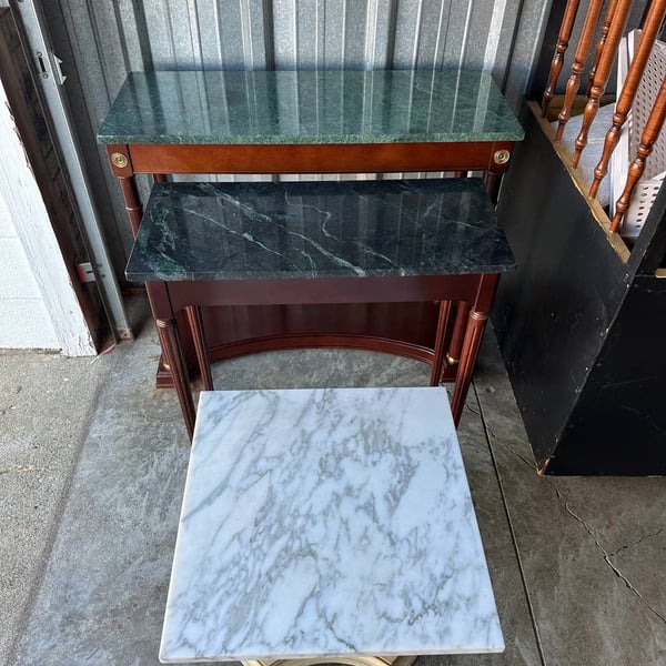 A set of three vintage tables with marble tops