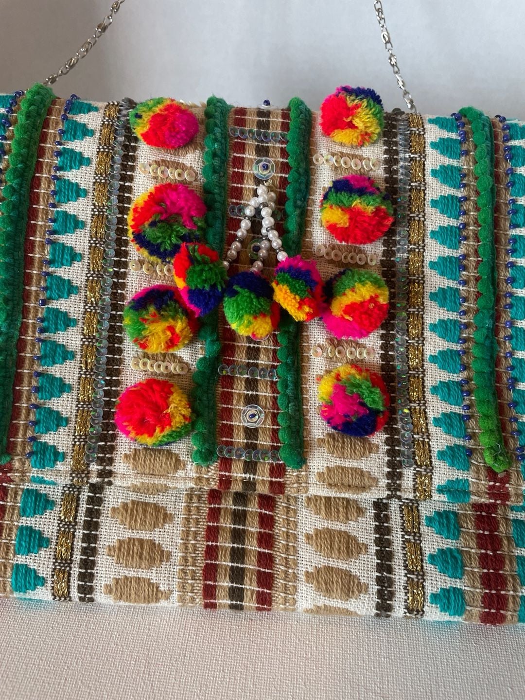 Charade Boho Embroidered Woven Clutch with Pom Poms and Chain Strap. 4