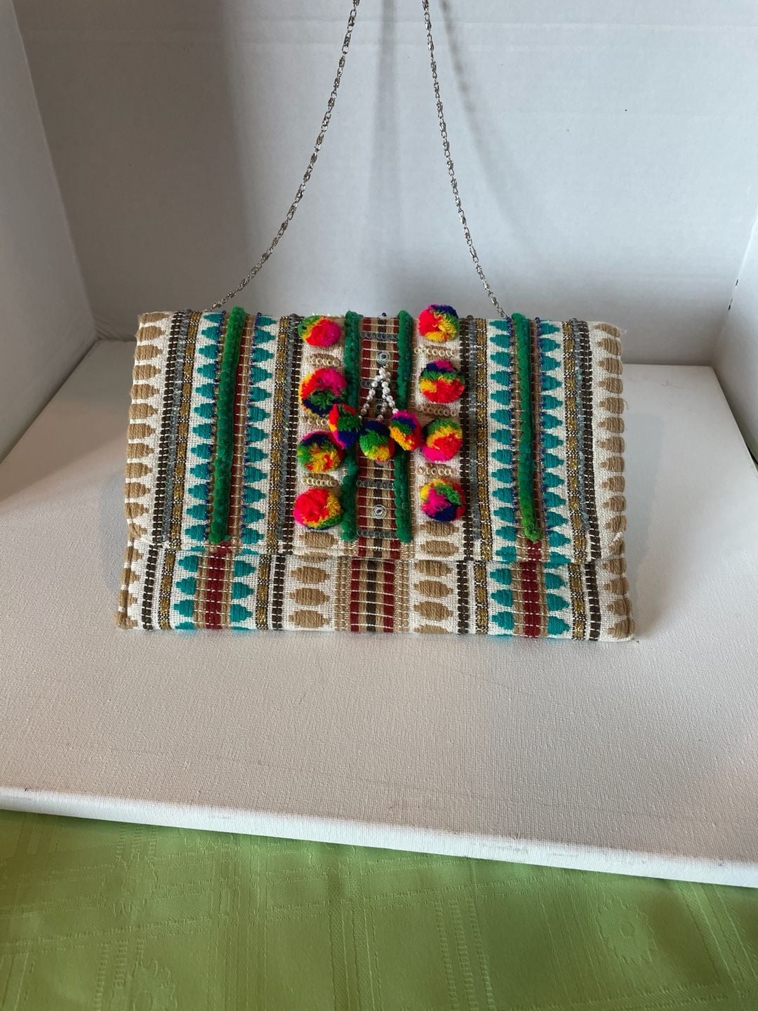 Charade Boho Embroidered Woven Clutch with Pom Poms and Chain Strap. 5