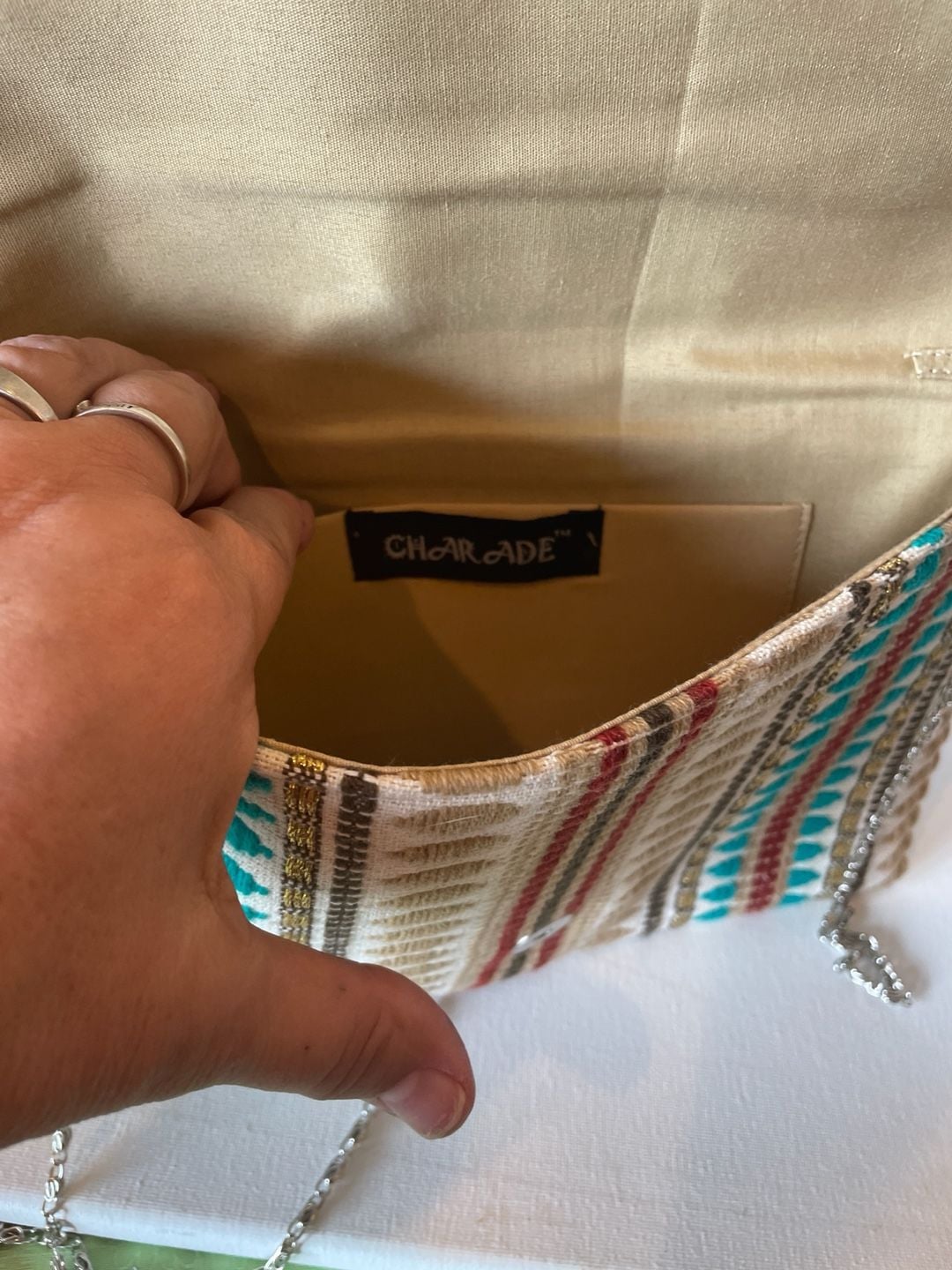 Charade Boho Embroidered Woven Clutch with Pom Poms and Chain Strap. 8