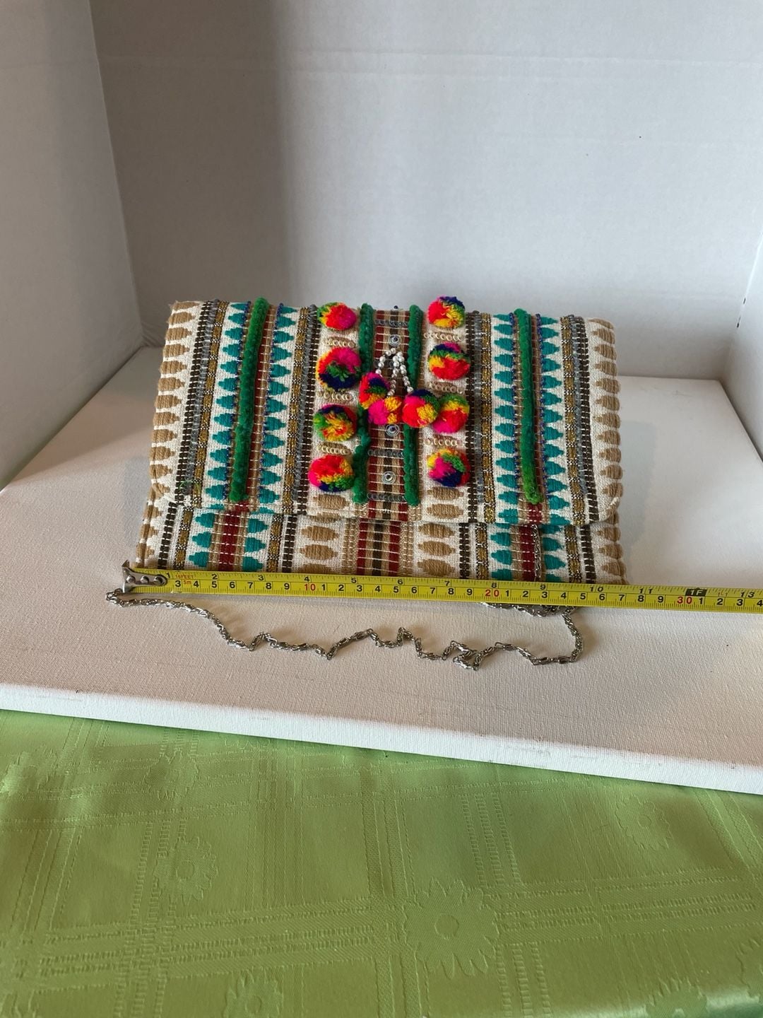 Charade Boho Embroidered Woven Clutch with Pom Poms and Chain Strap. 14