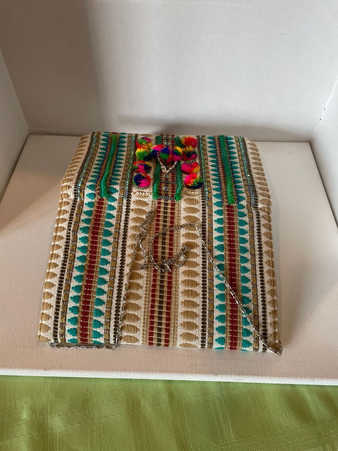 Charade Boho Embroidered Woven Clutch with Pom Poms and Chain Strap. 16