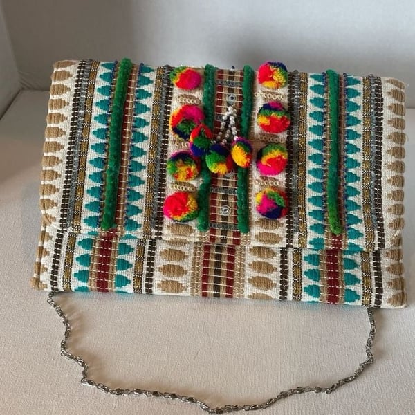 Charade Boho Embroidered Woven Clutch with Pom Poms and Chain Strap.