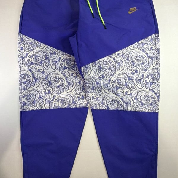 Nike Women's Sportswear Lapis Blue Paisley Lace Inset Track Pants DR6702-430 fit on men’s size Large. 