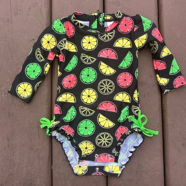 RuffleButts Neon Citrus Long Sleeve One-Piece Rash Guard Swimsuit