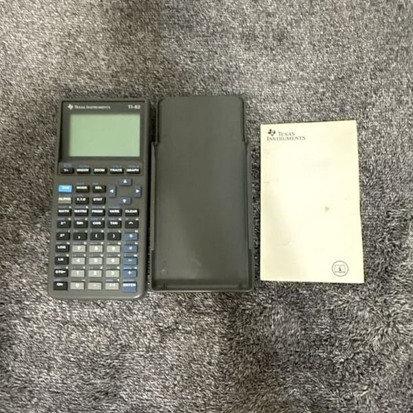 Texas Instruments TI-82 Graphing Calculator with Slide Case and Manual