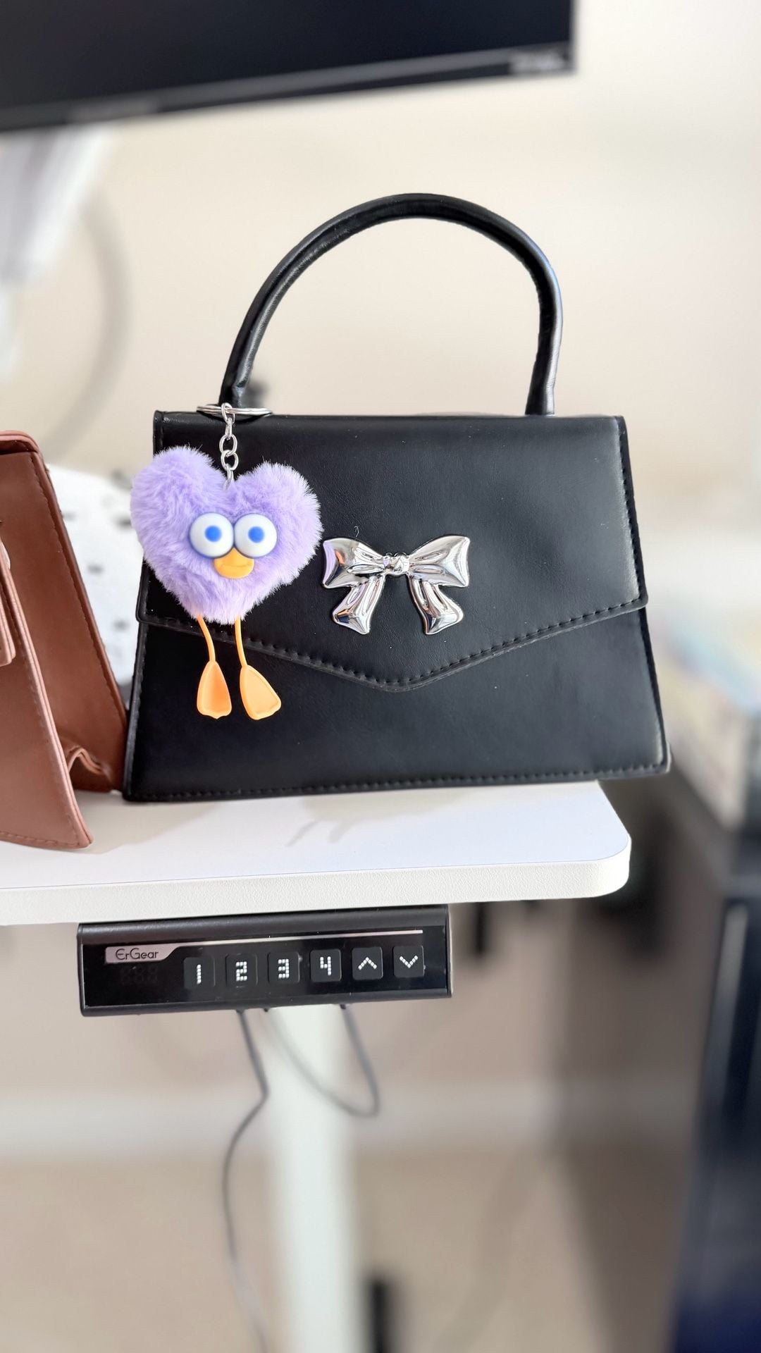 Minimalist Black Mini Square Handbag with Silver Bow Detail and Purple Heart Character Keychain 7