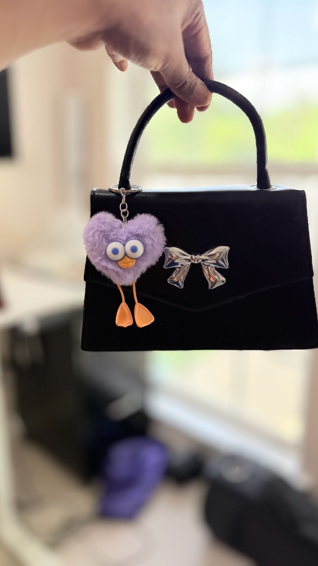 Minimalist Black Mini Square Handbag with Silver Bow Detail and Purple Heart Character Keychain 10