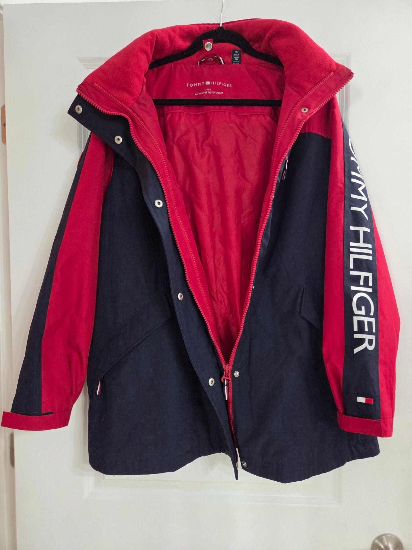 Tommy Hilfiger Women's 3-in-1 All Weather System Jacket in Red and Navy. Adjustable hood and hand cuffs, 2 zipper pockets and 2 zip-up sizes (see pic). 2