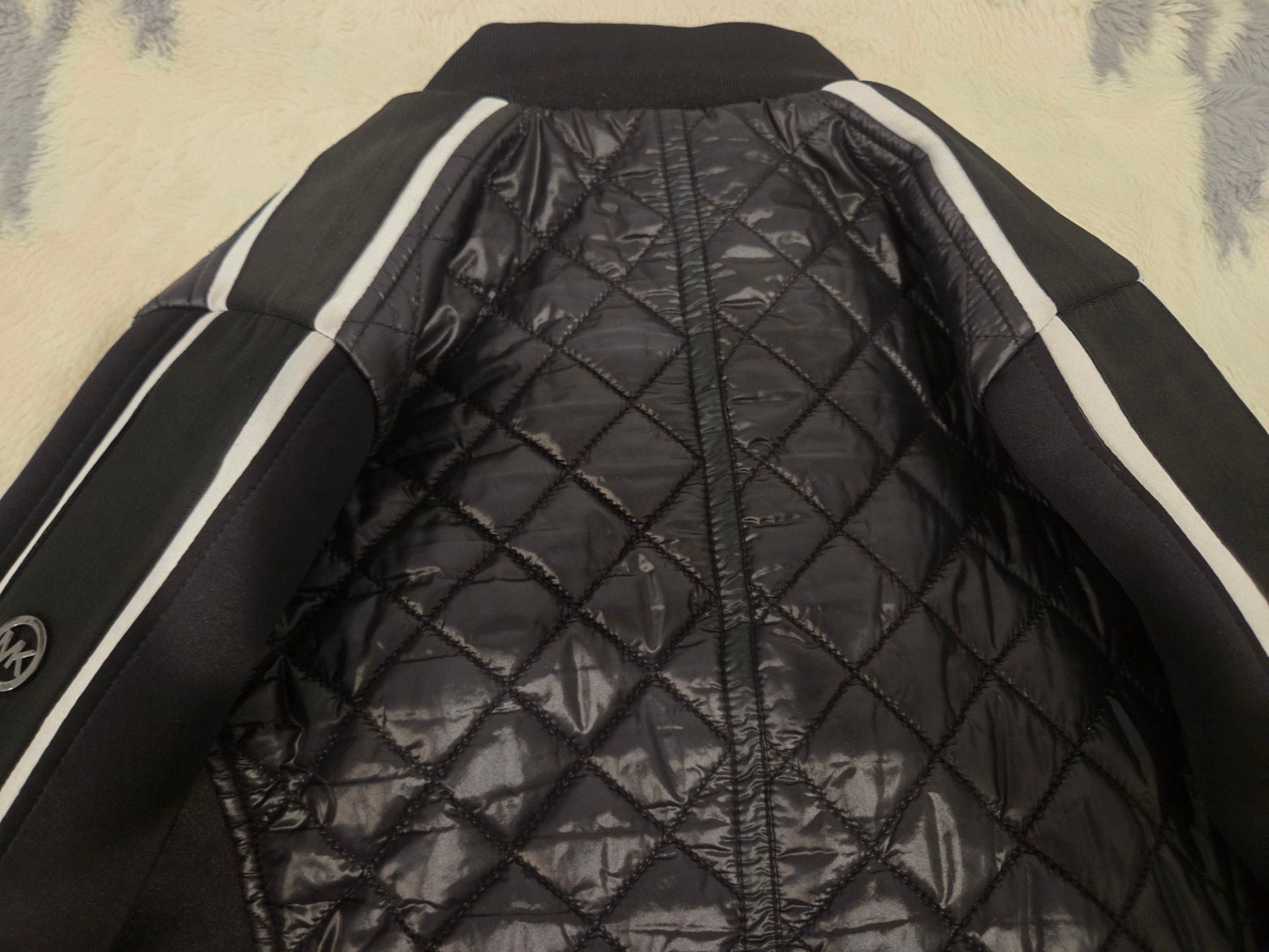 Michael Kors Women's Quilted Bomber Jacket with Contrast Stripe Sleeves.
*Estimated value is $85 on sellraze* 8