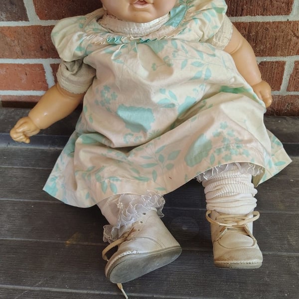 Vintage Vinyl Baby Doll with Blue Sleep Eyes and Floral Dress