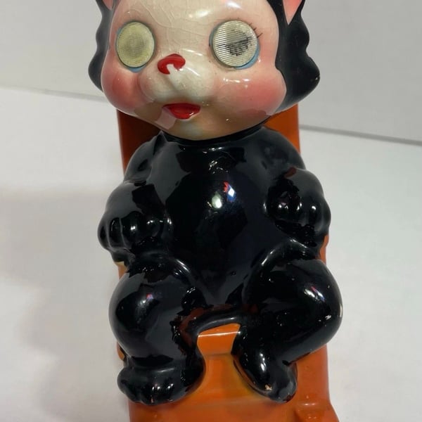 Vintage black cat in orange rocking chair ceramic coin bank Approx 1960s