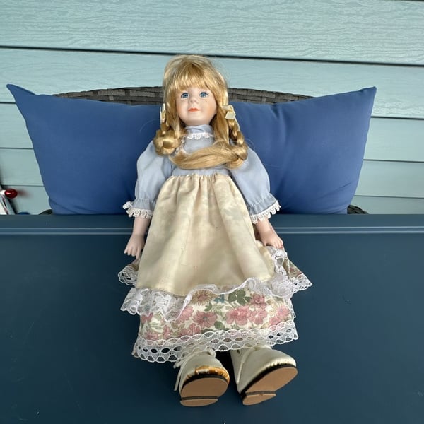 Vintage Blonde Porcelain Collectible Doll with Blue Dress and Floral Apron
