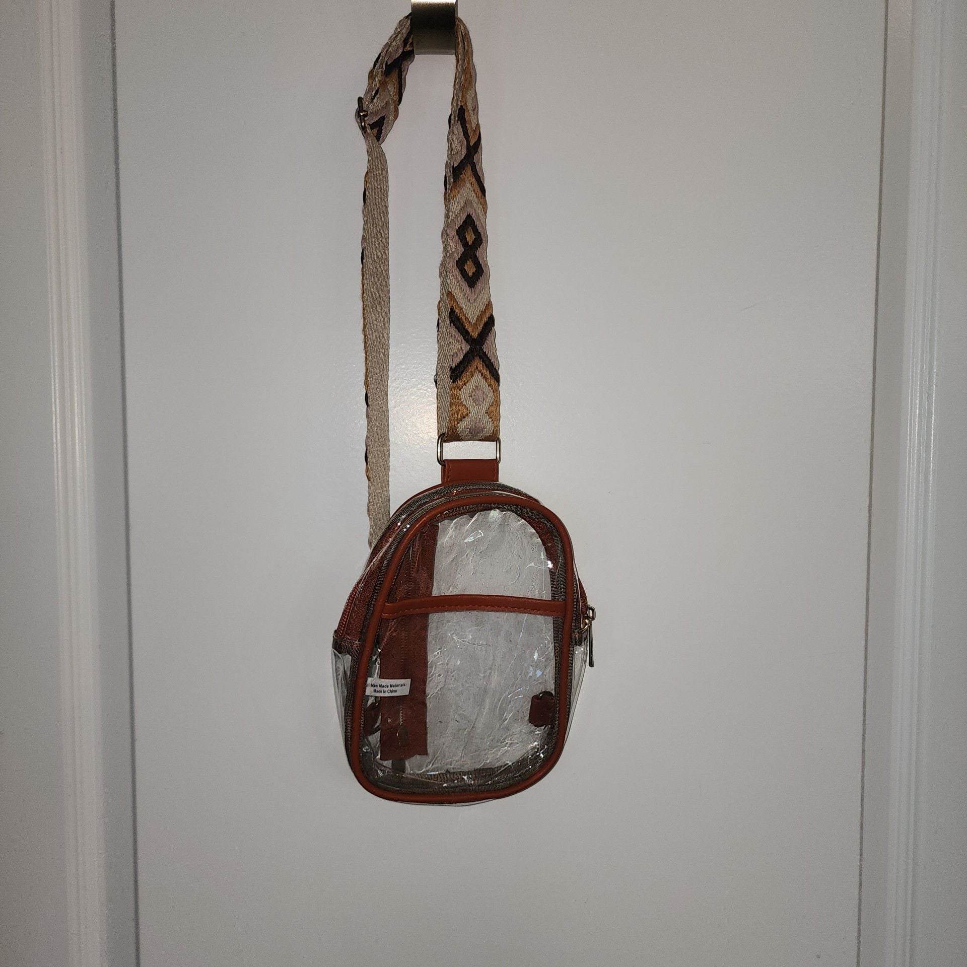 Clear Sling Crossbody Bag with Brown Trim and Patterned Guitar-Style Strap 1