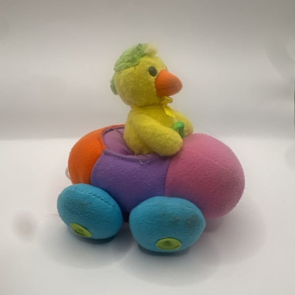 Vintage Pull-Back Toy Chick Driving a Multi-Colored Plush Bumper Car