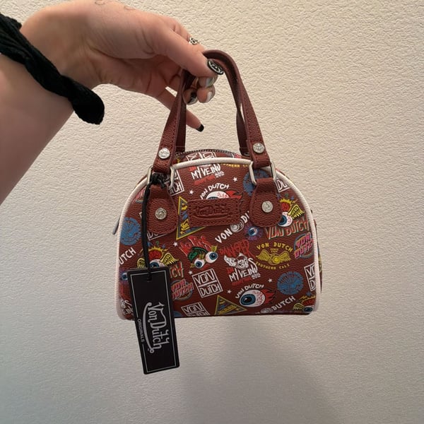Von Dutch Jax Bowling Bag in Brown with Multi-Color Graphic Logo Print
