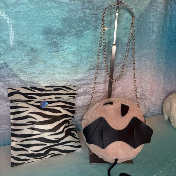 Pink Faux Fur Bat Wing Devil Crossbody Bag with mystery bag of fun accessories.