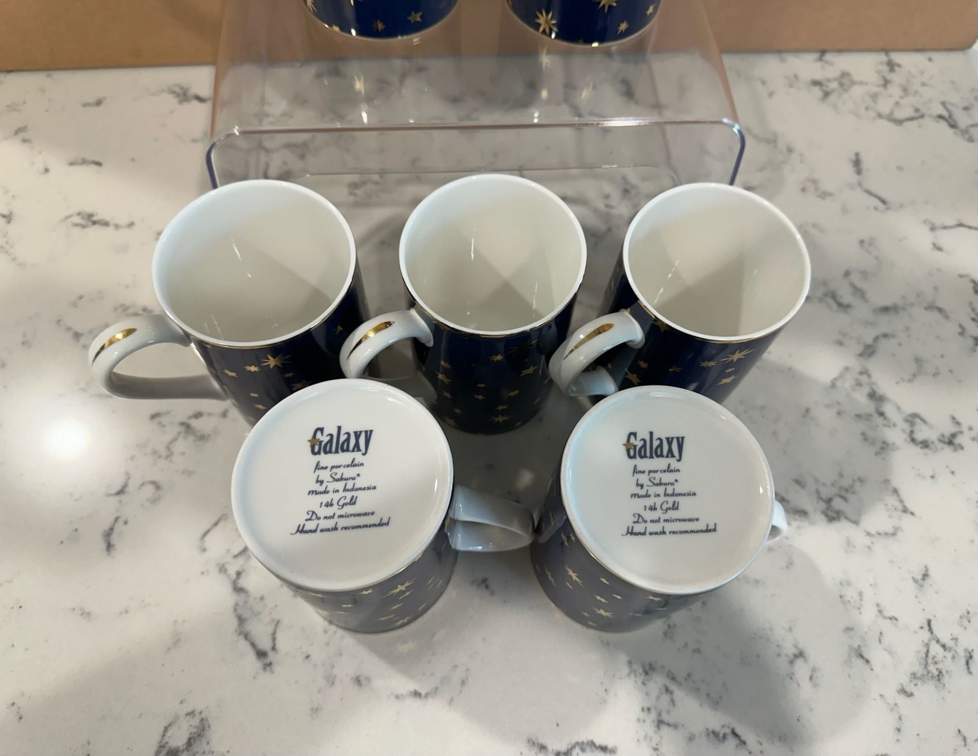 Pre owned, set of 8, Sakura Galaxy Blue porcelain coffee mugs featuring a navy blue celestial star pattern and 14K gold trim, Approximate Size: About 4 1/4 inches tall. Great condition, One of the cups has minimal sign of use, please refer to the photogra 2
