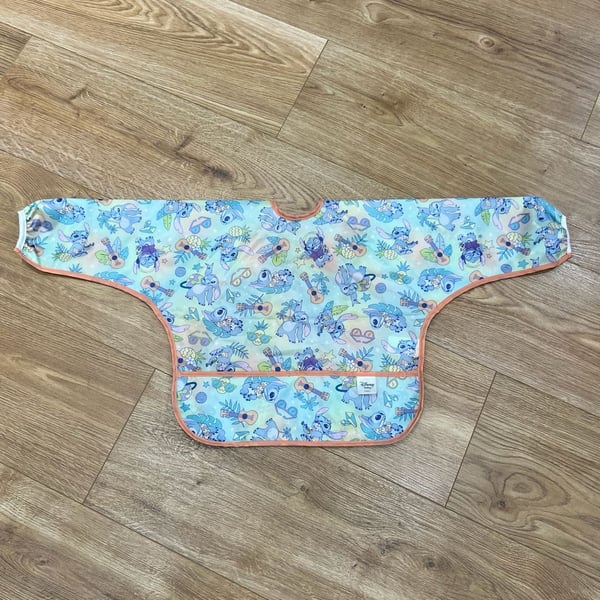 Bumkins Disney Aloha Stitch Sleeved Bib Waterproof Pocketed Tie Back