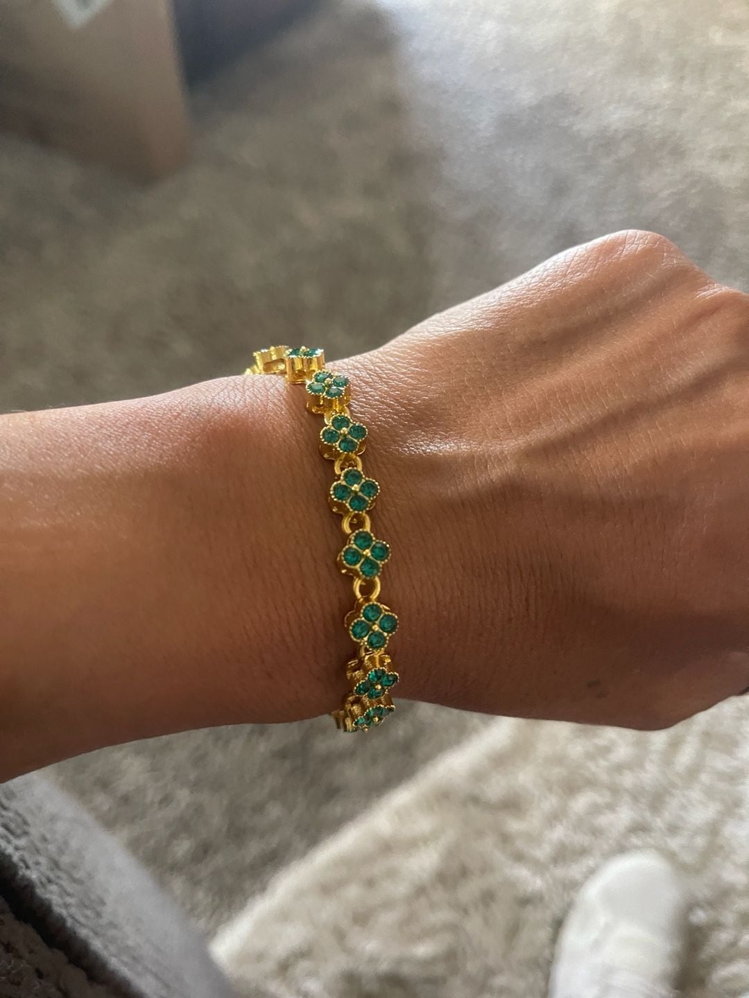 Gold tone tennis bracelet with four leaf clover shaped links. 4