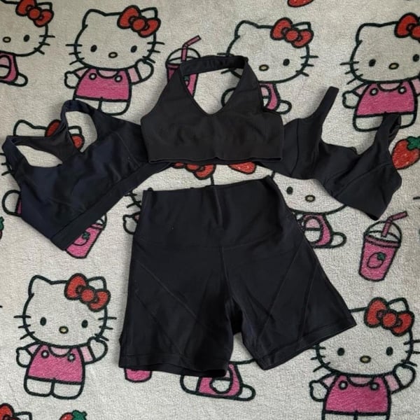 Black Athletic Activewear Set Including Ribbed Halter Crop Top, Sports Bra, and High-Waisted Biker Shorts