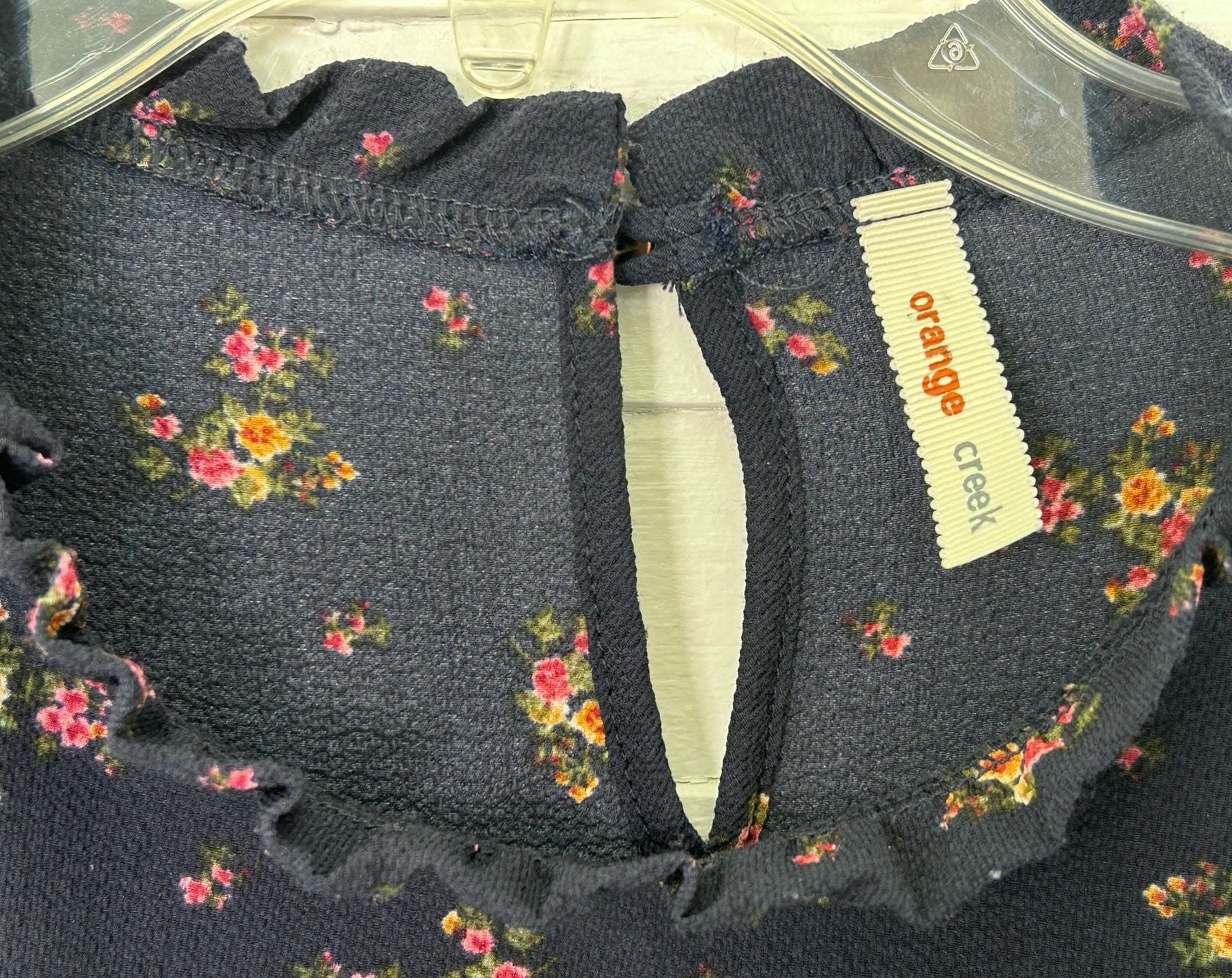 Orange Creek boho navy floral long sleeved blouse with ruffle collar and hem. 4