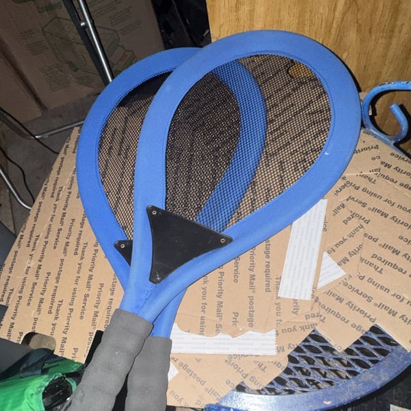 Blue Mesh Tennis Racket with Black Grip and Metal Plate