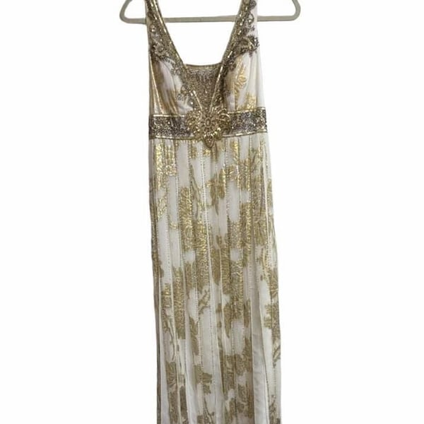 Sue Wong Gold And Cream Empire Waist Gown.
Hand-Applied Embellishments: Individual gowns often feature thousands of hand-stitched beads, sequins, and crystals combined with complex techniques like passementerie and soutache. 
Historical and Vintage Fusion