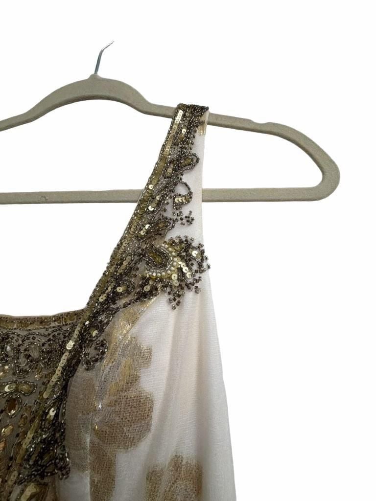 Sue Wong Gold And Cream Empire Waist Gown.
Hand-Applied Embellishments: Individual gowns often feature thousands of hand-stitched beads, sequins, and crystals combined with complex techniques like passementerie and soutache. 
Historical and Vintage Fusion 8