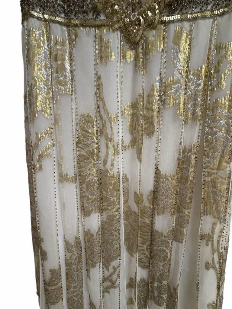 Sue Wong Gold And Cream Empire Waist Gown.
Hand-Applied Embellishments: Individual gowns often feature thousands of hand-stitched beads, sequins, and crystals combined with complex techniques like passementerie and soutache. 
Historical and Vintage Fusion 10