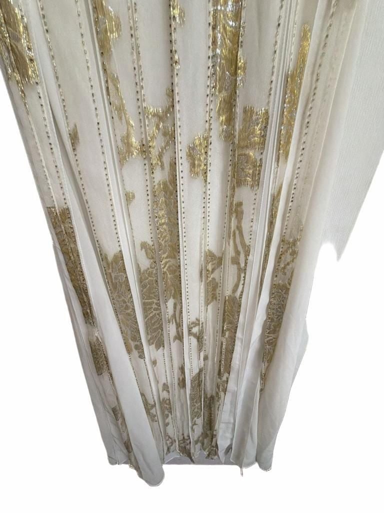 Sue Wong Gold And Cream Empire Waist Gown.
Hand-Applied Embellishments: Individual gowns often feature thousands of hand-stitched beads, sequins, and crystals combined with complex techniques like passementerie and soutache. 
Historical and Vintage Fusion 11