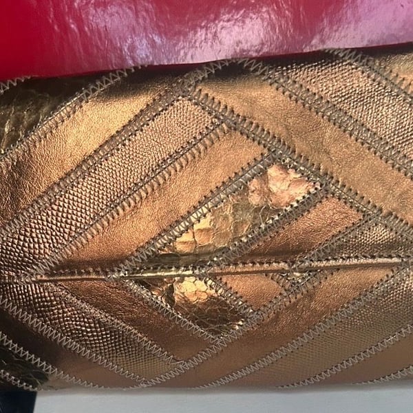 Gold Metallic Clutch Bag with Geometric Stitching and Embossed Pattern