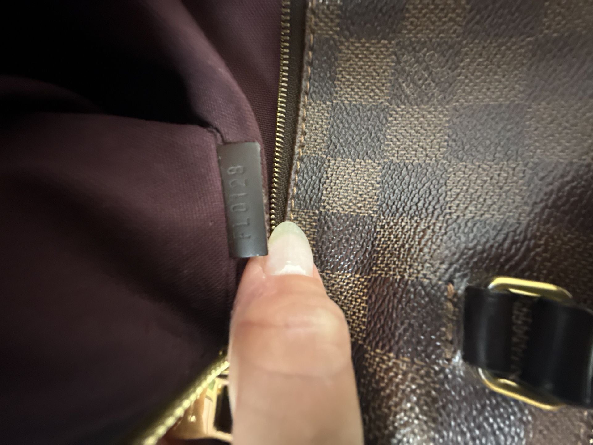 Louis Vuitton Damier Ebene Iena shoulder bag crafted in the signature brown checkerboard coated canvas with gold-tone hardware and a front zippered pocket. 8