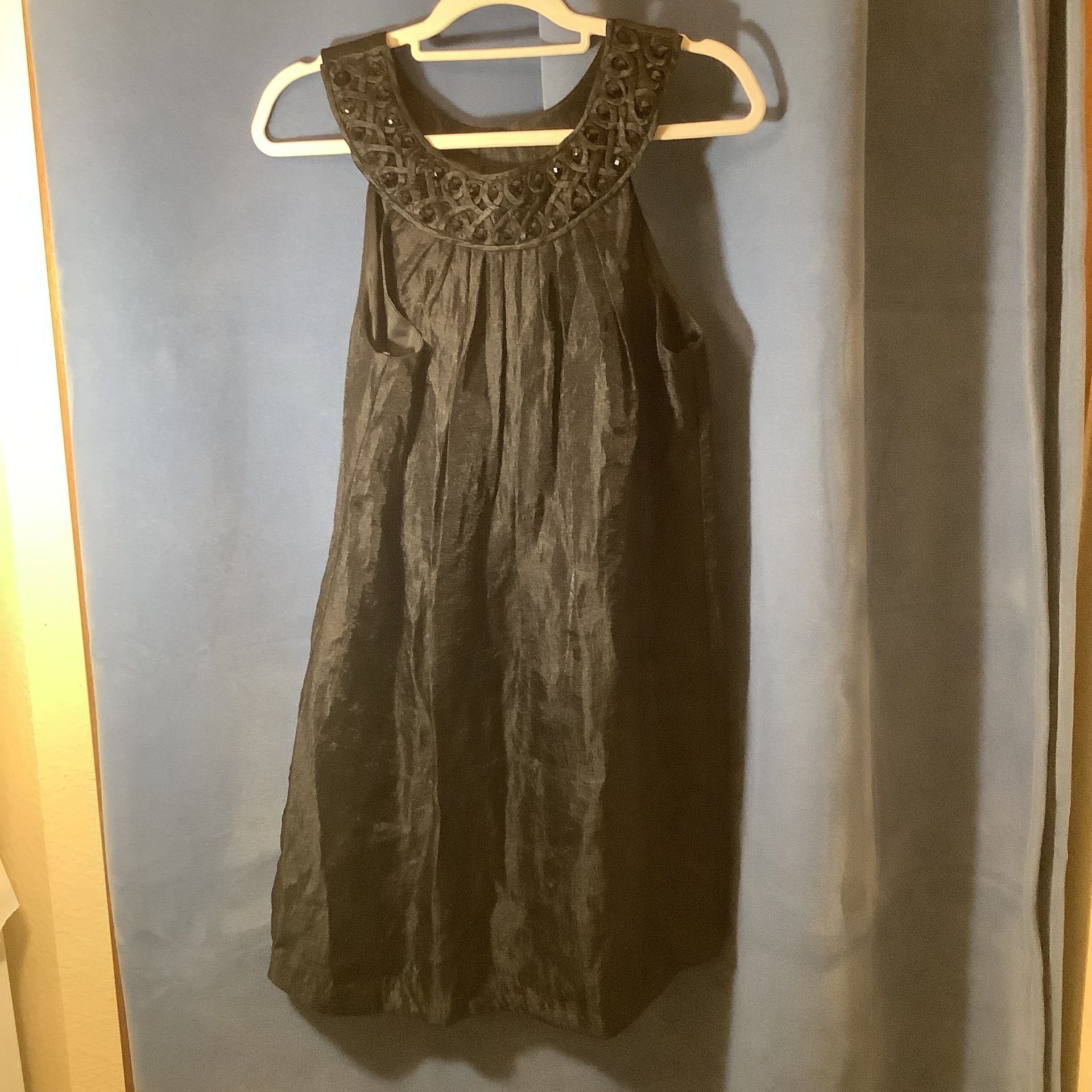 Elegant Black Sleeveless Dress with Embellished Neckline 2